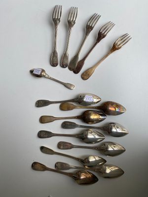 a lot of silver spoons and forks arranged in a circle