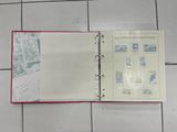 an open book with stamps on it sitting on a tiled floor