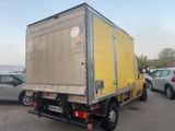 a yellow truck that is parked in a parking lot