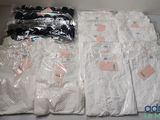 many bags of clothing that are on the table