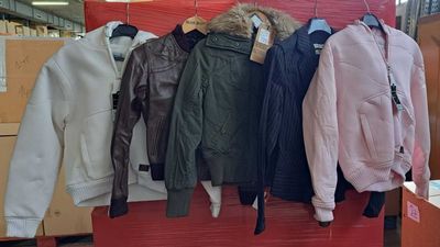 un grand nombre de vestes suspendues à un présentoir dans un magasin