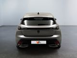 the rear end of a silver car in a white room