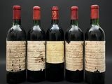 trois bouteilles de vin sont posées l'une à côté de l'autre sur une table