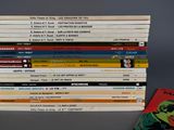 a lot of comic books stacked on top of each other