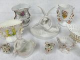 many different pieces of porcelain sitting on a table