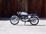 a motorcycle that is parked in front of a wooden fence