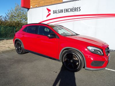 the red mercedes gla suv is parked in front of the balsam encheres building
