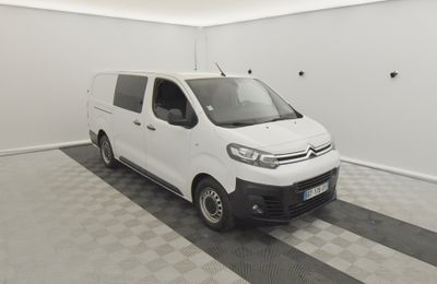 the white van is parked in a clean room with checkered flooring
