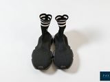 pair of black and white shoes with black and white stripes on them