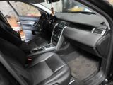 the interior of a car with the door open and the driver ' s seat down