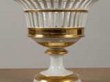 an image of a white and gold vase sitting on top of a wooden table