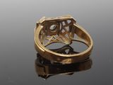 an image of a gold ring with a diamond in the center