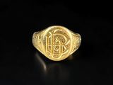 a gold ring with a celtic design on it