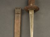 an old knife and a small knife on a gray surface