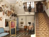 an image of a room with a lot of antelope heads on the wall