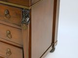 a small wooden chest of drawers with a marble top