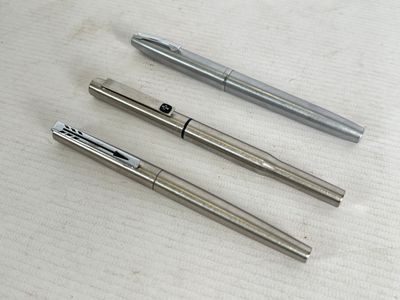 three different types of pens are lined up on a table