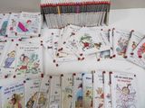 many children ' s books that are on the table