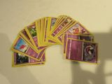 a lot of cards on the table with a shadow on the wall