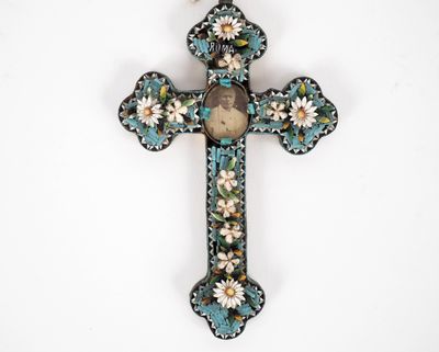 une image représentant une croix sur laquelle figure le portrait d'une femme