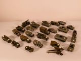 a lot of toy army vehicles on a white surface