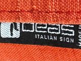 an orange beanie hat with a black and white label on it