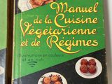 two books on a table with a plate of food in front of them