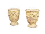 two vases sitting next to each other on a white surface