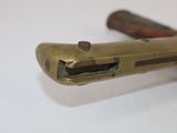 a close up of a metal object on a white surface