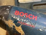 a close up of a person holding a drill in their hand