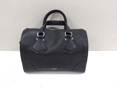 a black handbag sitting on top of a white table