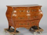 a small wooden chest of drawers on wheels on a gray background
