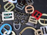a lot of different types of buckles on a table
