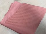 a piece of pink fabric on the floor next to a pair of scissors