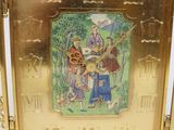 a gold frame with a picture of a man and a woman on it