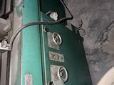 a green machine that is sitting next to a wall