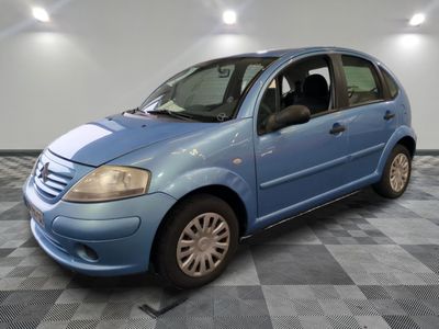 la photo d'une petite voiture bleue garée sur un sol en damier