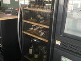 bottles of wine are lined up in a wine cooler in a restaurant