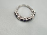 a close up of a ring on a table with a white background