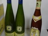 three bottles of wine sitting next to each other on a table