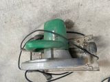 a picture of a green and black machine on a concrete floor