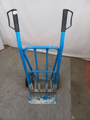a blue hand truck that is sitting on the floor