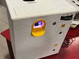a white refrigerator that is sitting on top of a red table