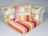 a colorful striped chair with a pillow on it