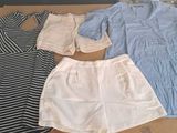 three pieces of clothing sitting on a table in front of a window