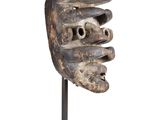 an image of a wooden mask on a stand on a white background