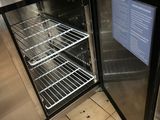 a small refrigerator with a door open in a kitchen