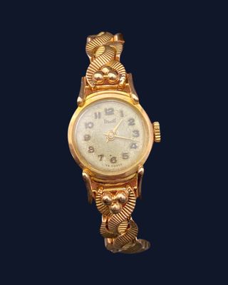 an image of a gold watch on a black background