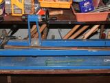 un établi bleu avec des outils dessus, dans un garage