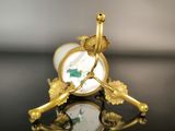 a gold clock sitting on top of a black table